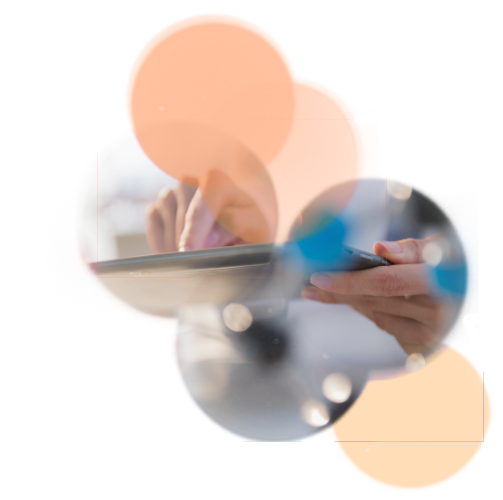 a hand taps a tablet with lens flare